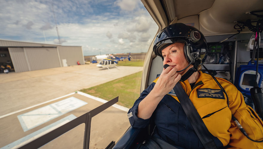 Flight nurse using communications system during takeoff