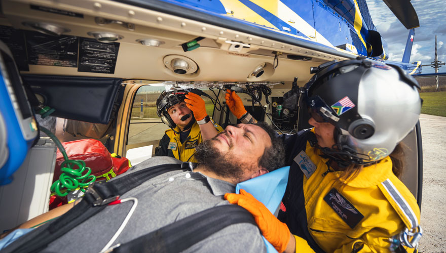 Medical team attending to patient in helicopter