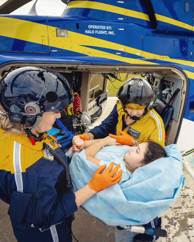 Flight-nurses-loading-girl-onto-helicopter